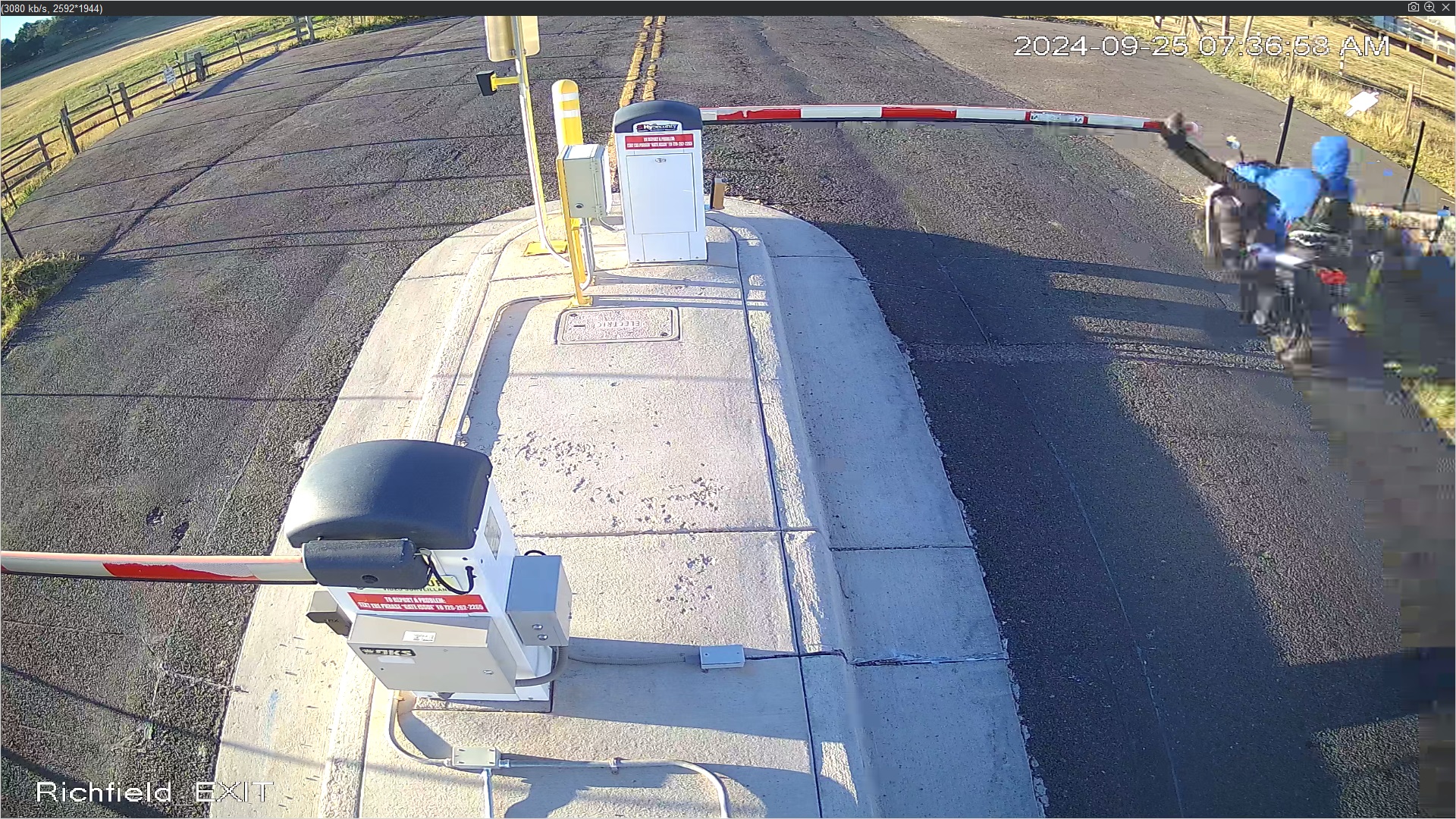 Person with blue hoodie on white scooter kicking gate